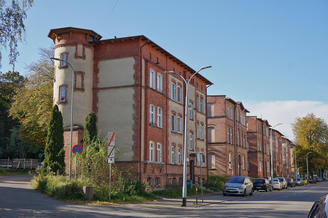 Red brick apartment houses on a street in Gdańsk in autumn